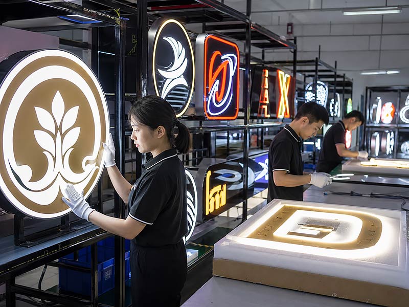 Custom LED signs undergoing 72-hour lighting test, quality inspection and packaging check before shipment