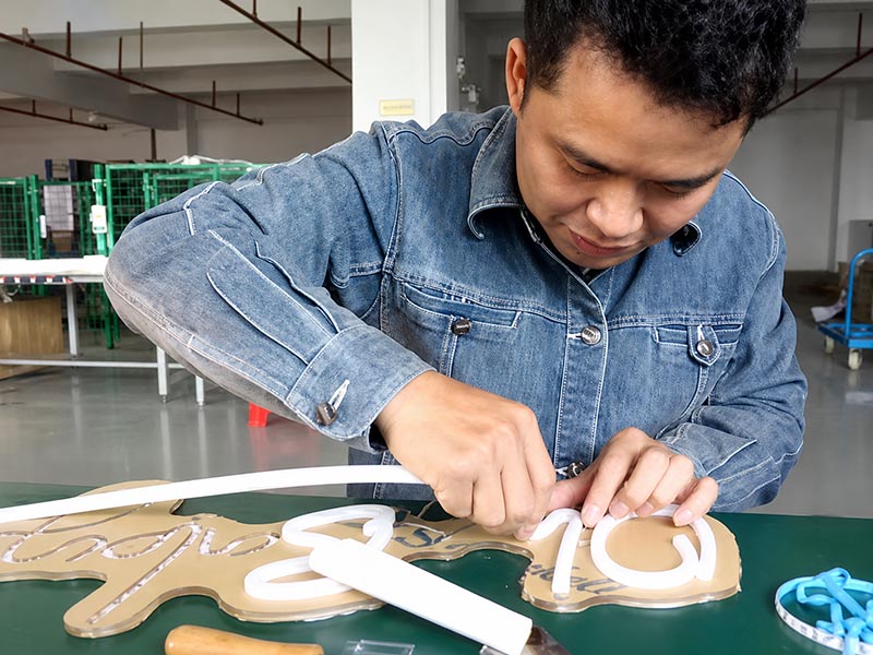 LED neon sign silicone tube installation and assembly process in a factory workshop