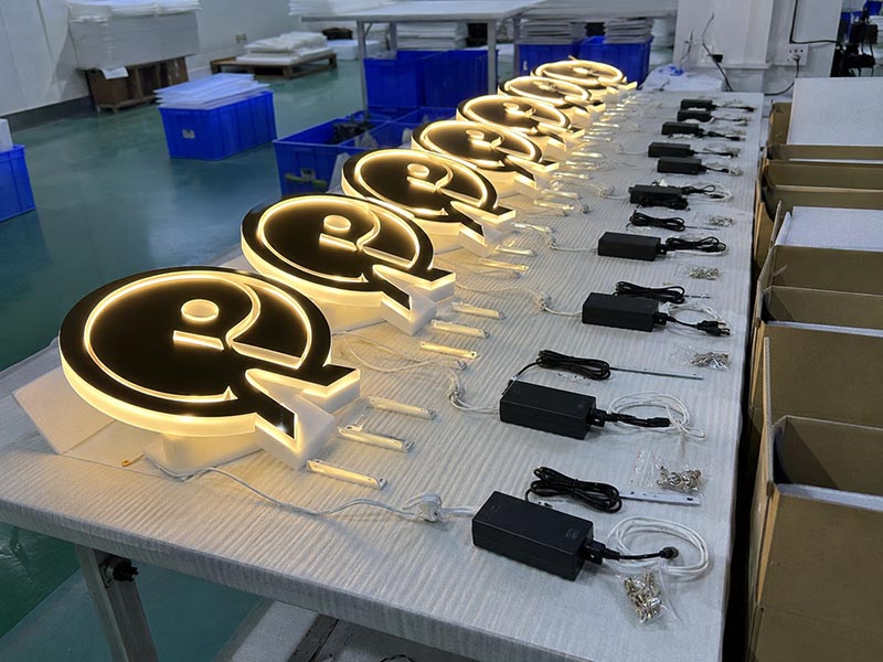 Matching acrylic LED logo signs prepared for a chain store rollout