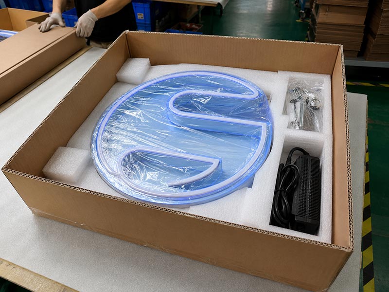 Custom LED sign packed in foam and protective film with separate accessory kit and power supply inside an export carton