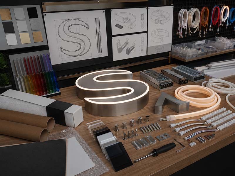 Custom LED sign export options including logo files, materials, lighting, mounting, voltage, and packaging