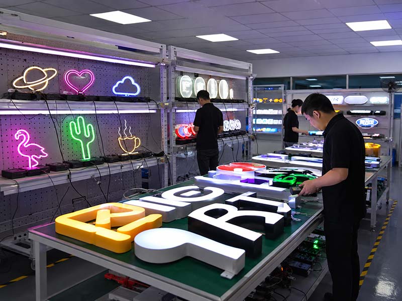 Custom LED signs undergoing 72-hour quality control testing with QC staff checking brightness, wiring, surface finish, and accessories