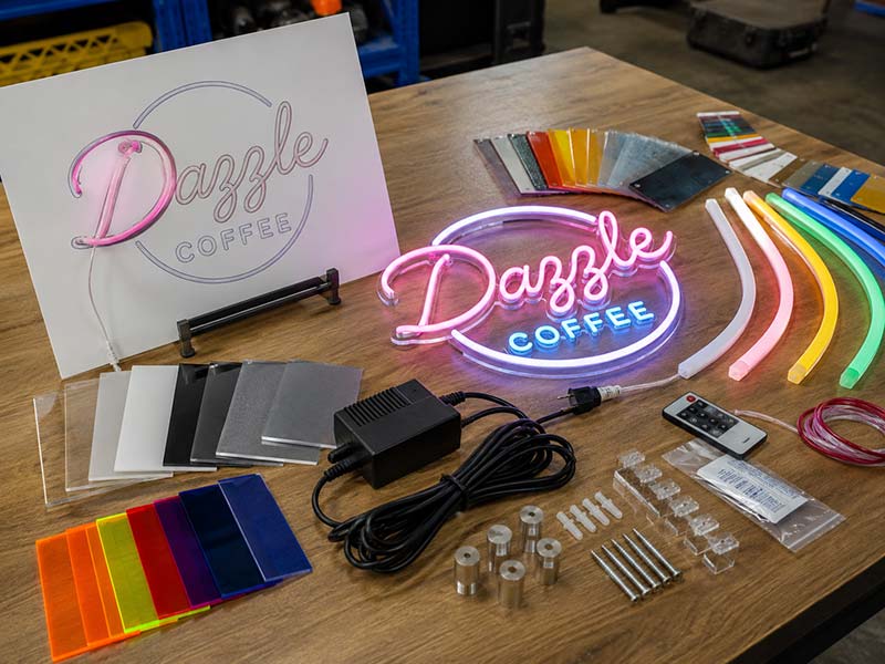 LED neon sign design review table with color samples, acrylic backing options, neon tube samples, power adapter, and mounting accessories.