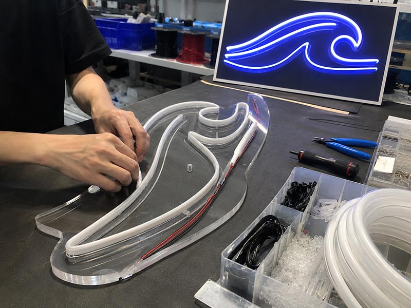 Custom LED neon sign manufacturing process with acrylic backing and silicone tubing assembly