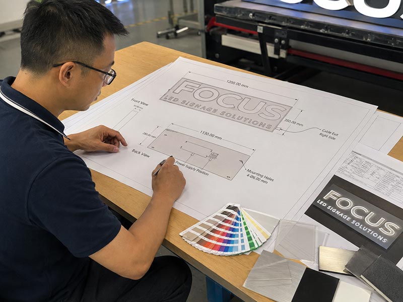 LED neon sign sample being tested in a workshop with lighting, wiring, and inspection details