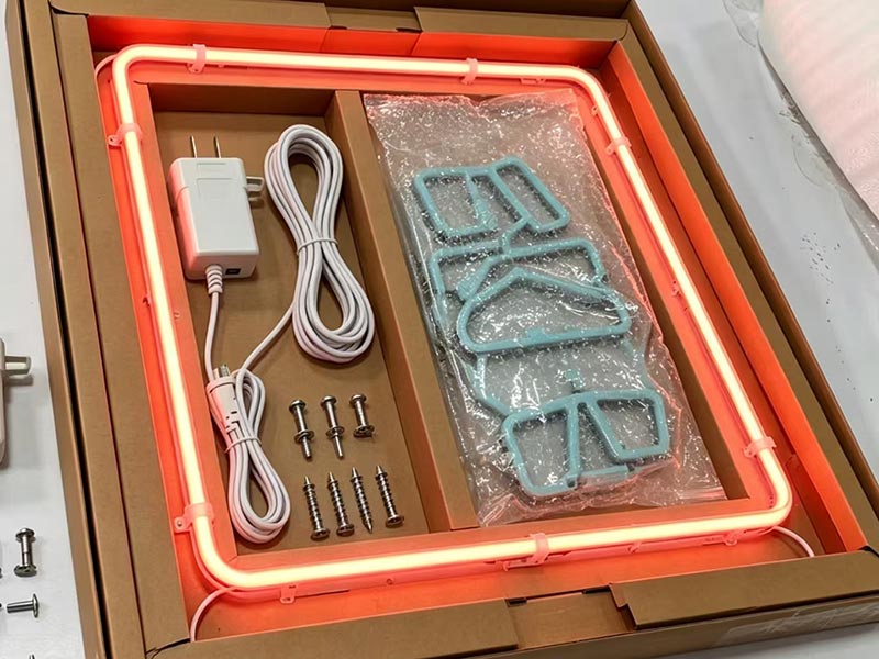 LED neon sign packaging kit with power adapter, cable, mounting screws, and protected sign accessories in a custom box