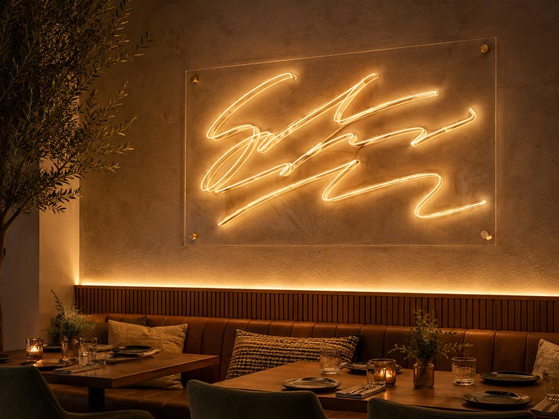 Custom LED neon text sign for restaurant feature wall