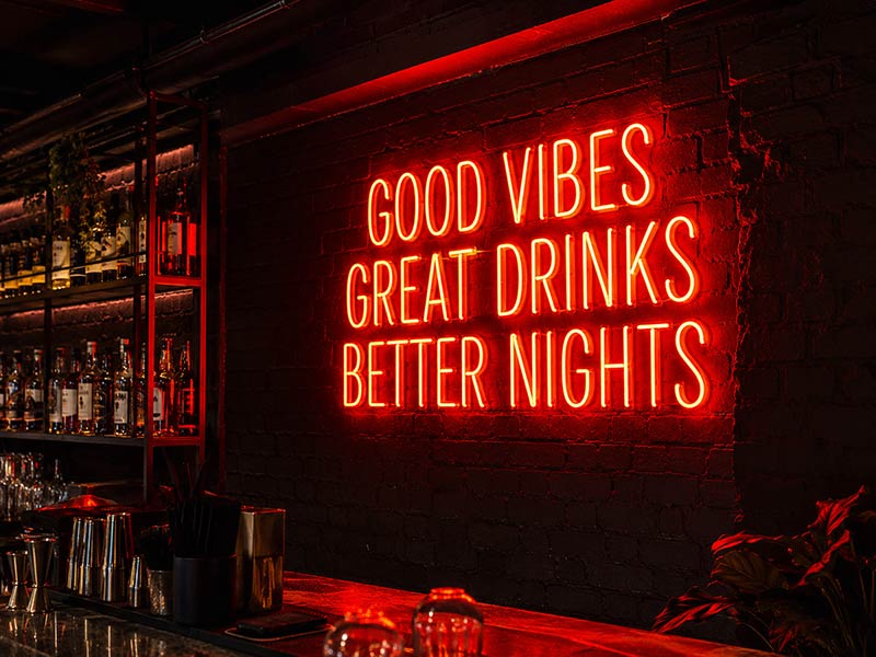 Custom LED neon slogan sign for a UK bar wall