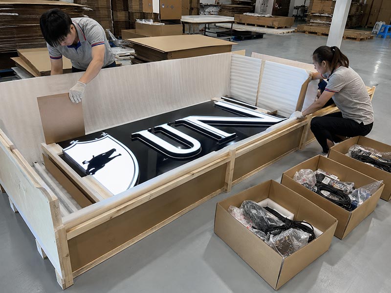 Custom LED sign packed with foam, wooden frame, and separated accessories for safe international shipping