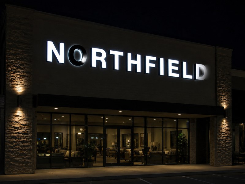 Front-lit channel letters showing dark areas and uneven illumination on a commercial storefront