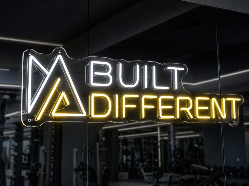 Custom gym neon sign with clear lettering and cut-to-shape acrylic backing