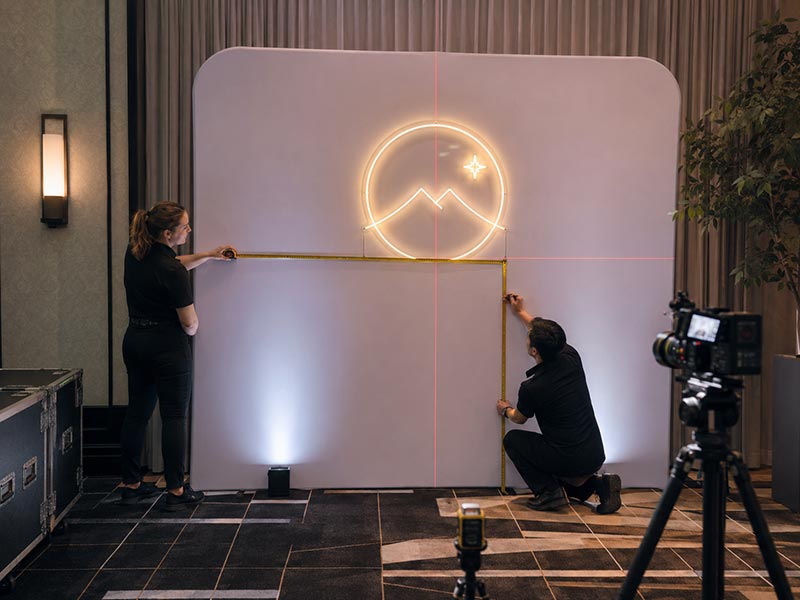 Measuring illuminated sign size and testing brightness on an event backdrop