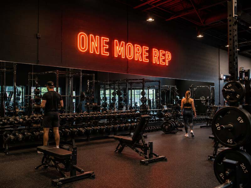 Motivational neon sign creating a clear focal point in a commercial gym