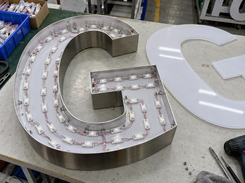 LED module spacing adjusted for channel depth, stroke width, face diffusion, and letter geometry
