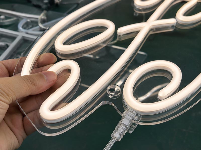 Close-up of LED neon sign showing tubing, acrylic backing, and connector quality