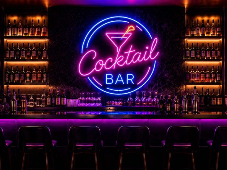 Custom RGB LED neon sign installed on a modern bar wall