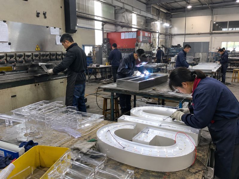 Custom sign factory controlling metal fabrication, acrylic processing, LED assembly, and wiring