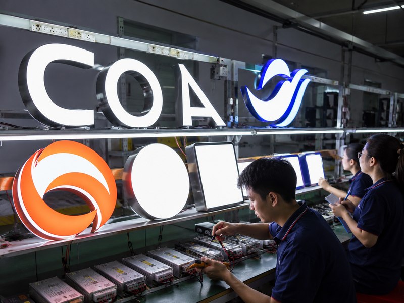Illuminated signs undergoing lighting and electrical pre-shipment testing in a sign factory