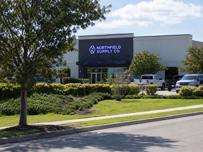 Commercial sign with viewing angle lighting setback and site obstructions affecting readability