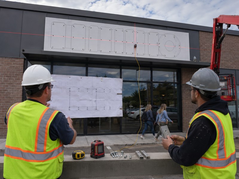 Storefront channel letter installation planning with mounting template, raceway, fasteners, and electrical connection